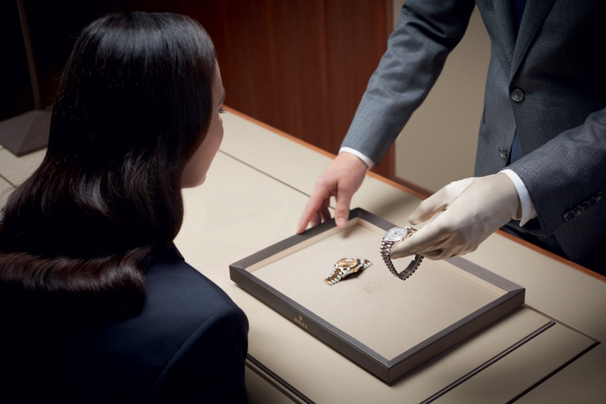 Person showing rolex watch to lady